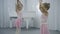 Two girls are having fun in ballet studio indoor.