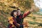 Two girls having fun in the park. Two cheerful girls in the autumn park. Two girls cheerfully spend time in the autumn