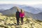 Two girls hikers standing in mountains enjoying mountain view