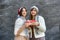 Two girls holding gift box. Celebration of the New Year or Christmas or birthday. Giving a present