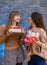 Two girls holding gift box. Celebration of the New Year or Christmas or birthday. Giving a present