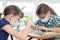 Two girls at home in isolation mode play board games