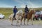 Two girls are horse riding, they wear horseriding caps, BlÃ¶nduÃ³s, Iceland