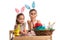 Two girls in kindergarten paint Easter eggs