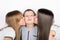 Two girls kissing boy