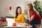 Two girls laughing together at table