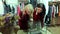 Two girls looking at accessories and jewelry on the counter in a clothing store.