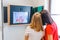 Two girls looking at Infrred camera in museum