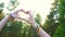 Two girls make heart hands at sunset,the sun,the symbol of LGBT people