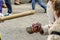 Two girls makes a wax balls, dripping from a candle in a procession of Holy Week in Huelva, Spain