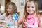 Two Girls Making Easter Decorations At Home