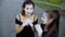 Two girls mimes imitate embarrassment when see camera