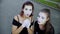 Two girls mimes imitate embarrassment when see camera