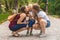 Two girls mom kiss their capricious little boy child in the park. Not a traditional family