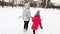 Two girls, mother and daughter, walking park in winter frosty day.