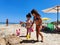 Two girls play on a beach in Salento in Italy