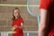 Two Girls Playing Badminton In School Gym