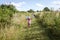 Two girls playing in green spring rural meadows