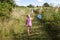 Two girls playing in green spring rural meadows