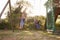 Two Girls Playing Outdoors At Home On Garden Swings