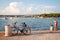 Two girls playing on a sea shore near a bicycle