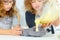 Two girls pouring cake mix