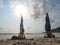 Two girls practice Shoulderstand yoga posture at seaside at sunrise