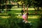 Two girls practice yoga in the park standing in the Revolved Triangle Pose