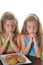 Two girls praying over cookies