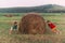 two girls pushing a haystack