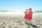 Two girls in red dress on the beach