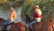 Two girls riding on horses bathed horses in lake.