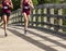 Two girls running race over wood bridge