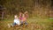 Two girls from running start jump in a heap of autumn leaves. Child playing in autumn garden. Fall foliage. Outdoor fun