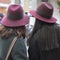 Two girls in the same burgundy hats make selfie