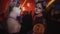 Two girls with santa muerte face paint dance at night club halloween party