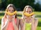 Two girls schoolgirl. In her hands holds banana. Summer in nature. The concept of healthy eating. Emotions are jokes and