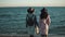 Two girls on the seaside admire the beautiful view. girlfriends spend time together outdoors.
