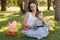 Two girls sisters: baby and teen with Easter chocolate eggs