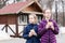 Two girls sisters eat pies bought in a food truck in a city park. Takeaway food