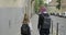 Two girls sisters going to school with backpacks, back view