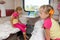 Two girls sisters on the train on lower ground in the second-class compartment wagon