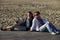 Two girls sits on the wooden bridge at beach