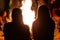 Two girls sitting in the front of fire