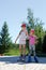 Two girls skate on roller skates in the park in the summer.