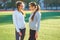 Two girls in sportswear posing at the stadium.Portrait of two sports girlfriends at the sports stadium