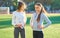 Two girls in sportswear posing at the stadium.Portrait of two sports girlfriends at the sports stadium