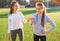 Two girls in sportswear posing at the stadium.Portrait of two sports girlfriends at the sports stadium