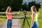 Two girls are students. Summer in nature. Conduct a conversation. Record vlog and blog. Record video lesson for Internet