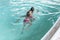 Two girls swim in the pool. Two sisters in the pool. Two happy girls play in the pool.Beautiful girls swim and having fun in water